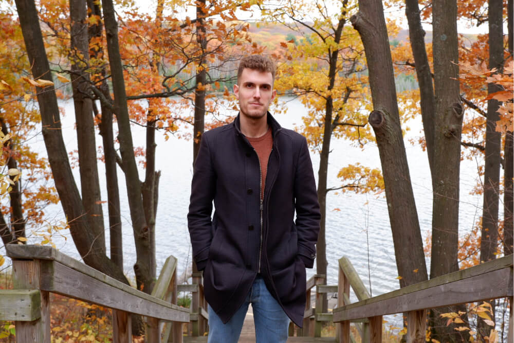 A picture of Daniele Grattarola standing in front of Kettle's Lake in Awenda Park, Ontario, Canada.s